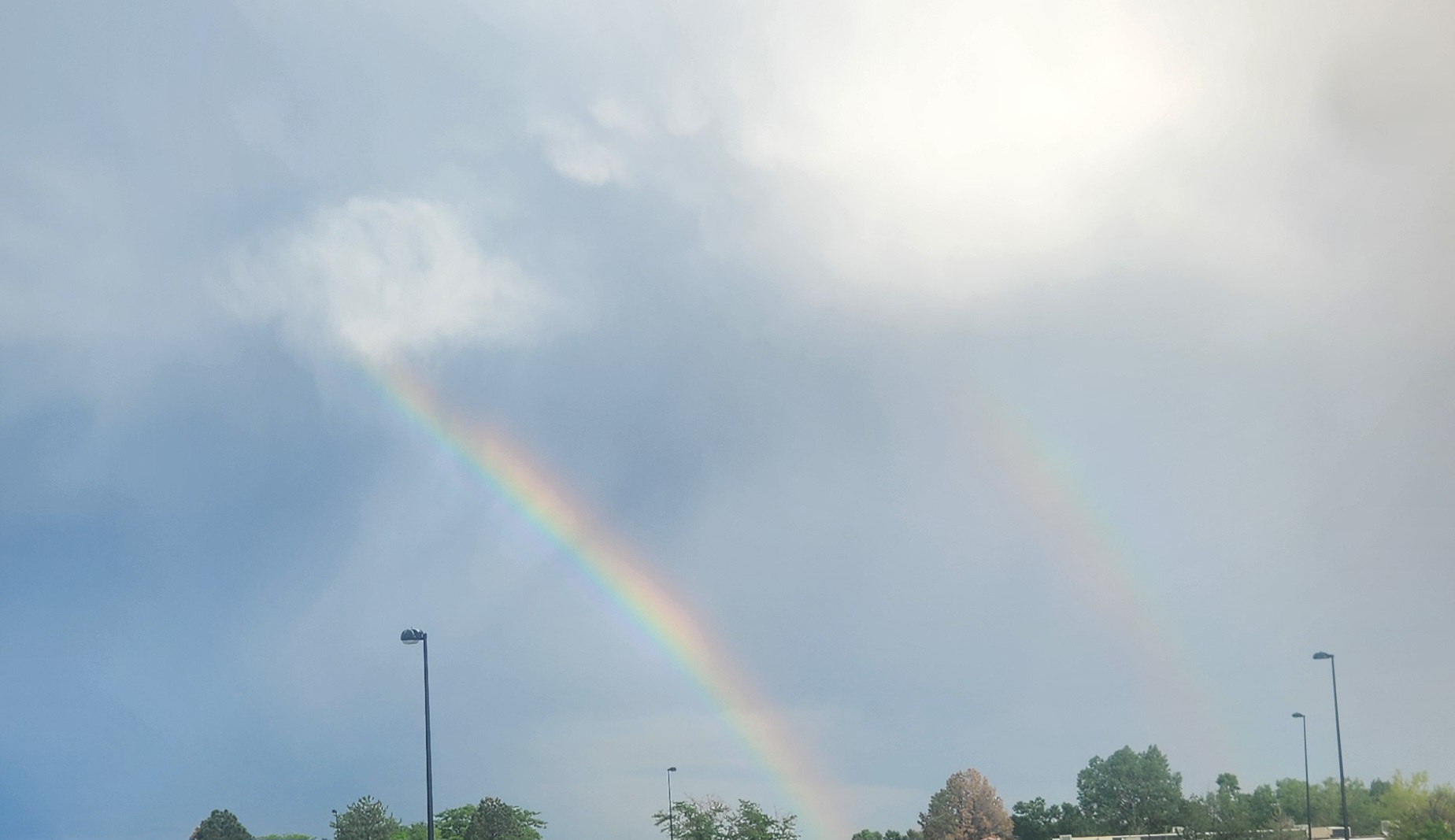 An image of a double rainbow on an overcast and rainy day.